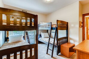 A bunk bed room with a wooden ladder, a small wooden table, and a window with a view. - Snow Chateau - Ski In/Out|Walk to Main St|Hot Tub (Breckenridge)