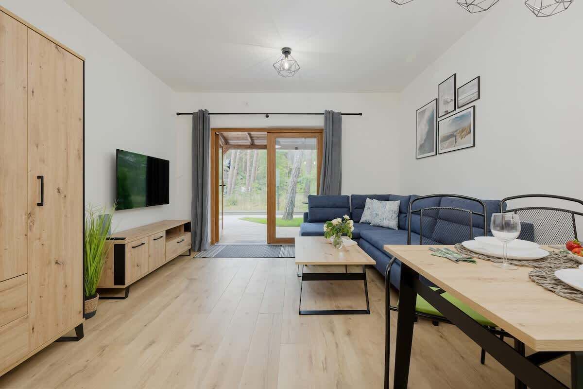 Cozy living room with sofa bed, TV and access to the terrace/patio.