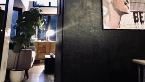 A modern interior with a dark wall, a potted plant, and a framed picture. - Townhouse Located Near Frontier Park and the Capitol Building (Cheyenne)
