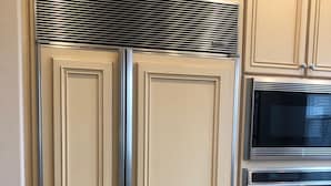 A kitchen with white cabinetry, a stainless steel range hood, a microwave, and an oven. - Stunning entire house in Channel Islands Marina (Oxnard)