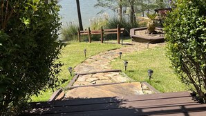 A wooden deck leading to a lake with a stone pathway and benches. - Perfect relaxing lake retreat for hosting a gathering. Quiet with no neighbors. (Westminster)