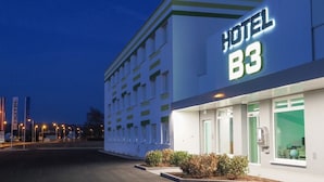 A hotel named B3 with a modern facade, large windows, and a well-lit entrance. - Hotel B3 (Mauthausen)