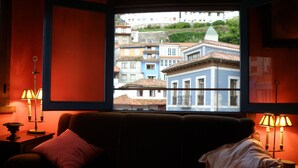 A cozy room with a large window overlooking colorful buildings. - SANTA JULINA (best viewpoint of all Cudillero) (Cudillero)