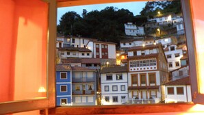 A view of a hillside town with buildings of various colors and architectural styles. - SANTA JULINA (best viewpoint of all Cudillero) (Cudillero)
