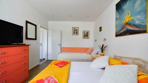 A hotel room with a bed, a red dresser, a television, and a painting on the wall. - A1 - apt in the Very Heart of Split With sea View (Split)