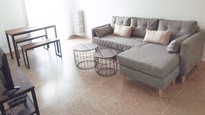 A living room with a grey sofa, two round side tables, a wooden coffee table, and a window with curtains. - A 2 PAS DES Plages DE LA Promenade DES Anglais!!!! (Nice)