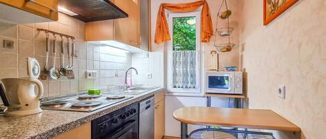 Fridge, stovetop, dishwasher, coffee/tea maker