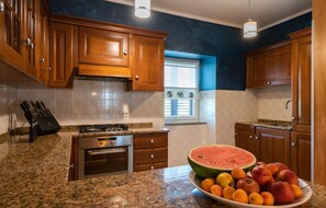 Fridge, stovetop, dishwasher, coffee/tea maker