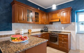 Fridge, stovetop, dishwasher, coffee/tea maker