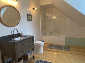 Combined shower/bathtub, towels, soap, toilet paper