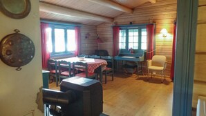 A rustic dining area with wooden walls and a table set for two. - Lovely home in Vikersund with sauna (Vikersund)