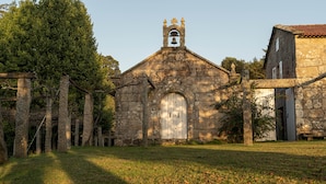 A stone church with a bell tower and arched entrance.