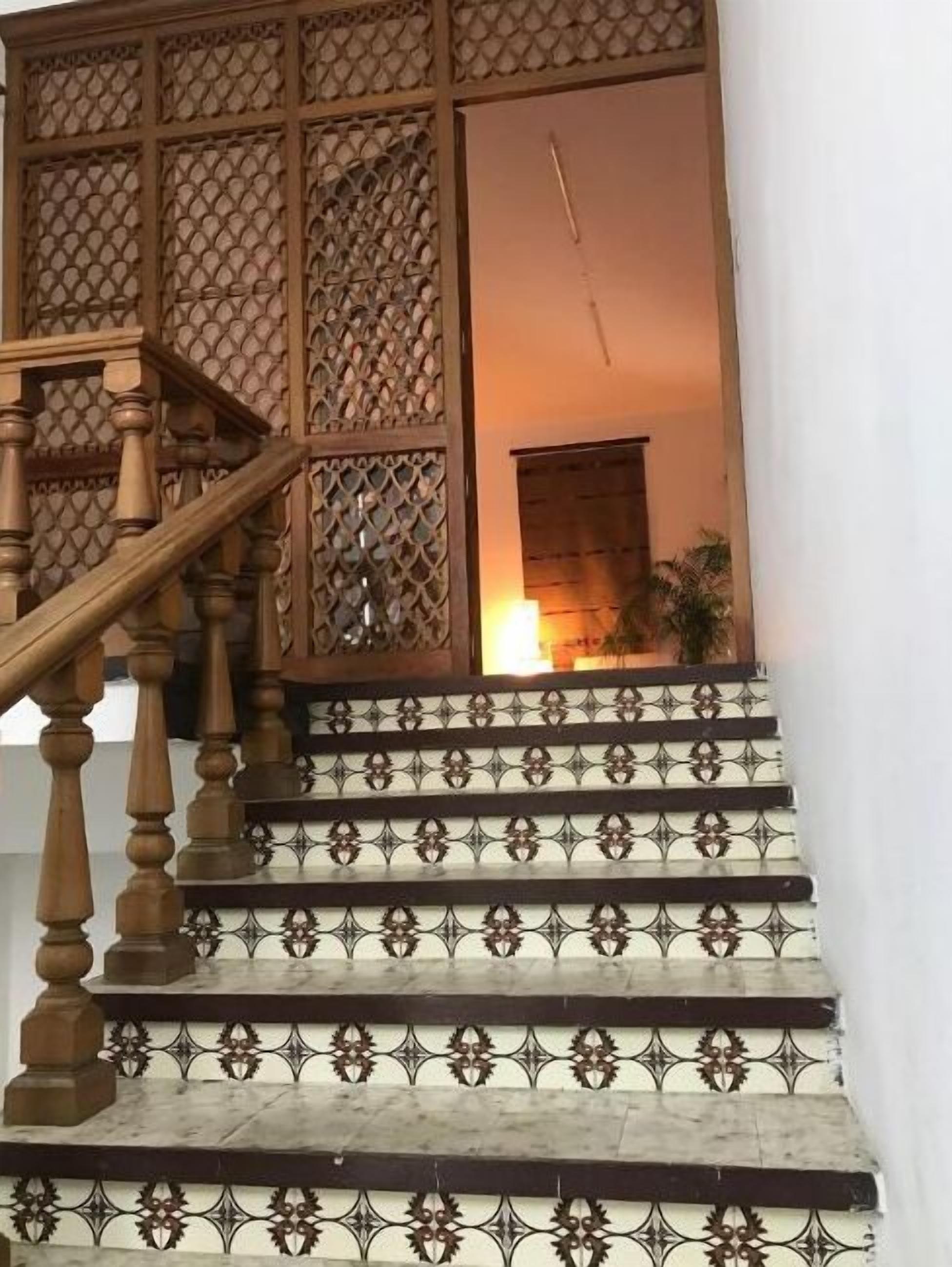 A staircase with ornate railings and patterned steps.