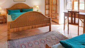 A room with a wicker bed, a desk, and a chair. - Pergola by Interhome (Boccheggiano)