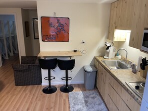 Fridge, dishwasher, coffee/tea maker, cookware/dishes/utensils
