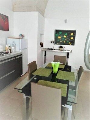 A modern kitchen with a dining area.