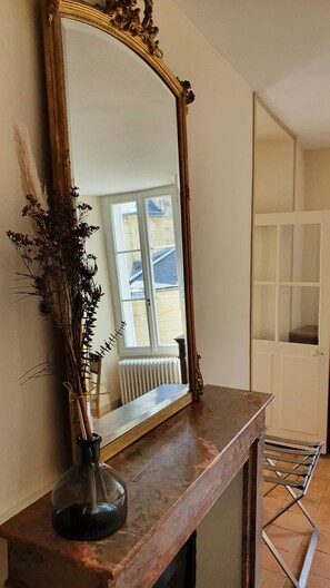 A mirror with an ornate frame on a wooden console table. - Les Destinées - Bed and breakfast (Chinon)