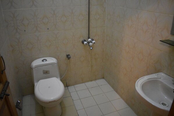 A small bathroom with a toilet, bidet, and sink.