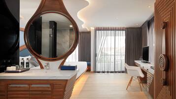 A modern bathroom with a large mirror, a bathtub, and a vanity with a sink and mirror.