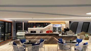 A modern bar area with a counter, seating, and a refrigerator labeled "Deluxe."