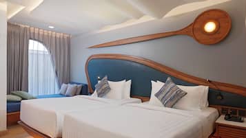 A hotel room with two beds, a wooden headboard, a nightstand, and a large window with curtains.