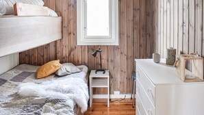 A compact, well-organized bedroom with a bunk bed, a small bedside table, a desk, and a dresser. - Cozy home in Sjusjøen (Sjusjøen)