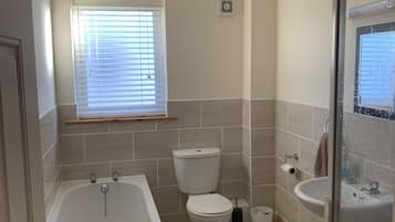 Bathtub, hair dryer, towels, soap