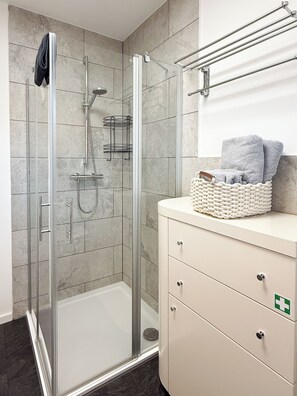 Shower, hair dryer, towels, soap