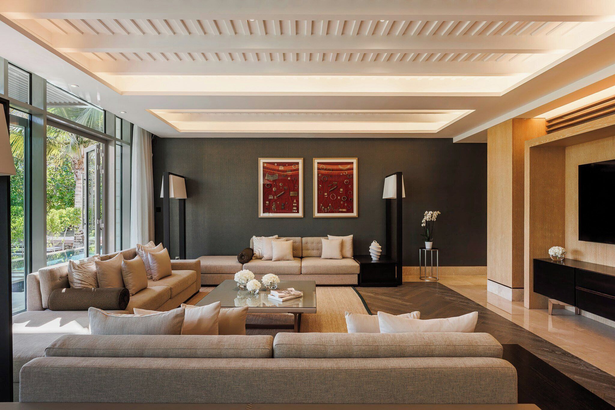 A modern living room with a sofa set, a coffee table, and a flat-screen TV.