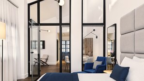 A modern hotel room with a large bed, a desk, and a chair. - Vanoro Hotel (Thessaloniki)
