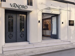 A modern hotel entrance with a dark door and a sign reading "VANORO". - Vanoro Hotel (Thessaloniki)