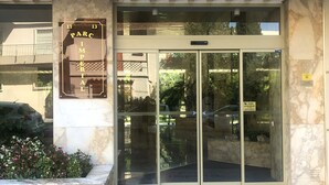 A hotel entrance with a glass door, a sign above the door, and a marble floor. - Lovely and bright apartment on the fifth floor with a large terrace. Garage! (Cannes)