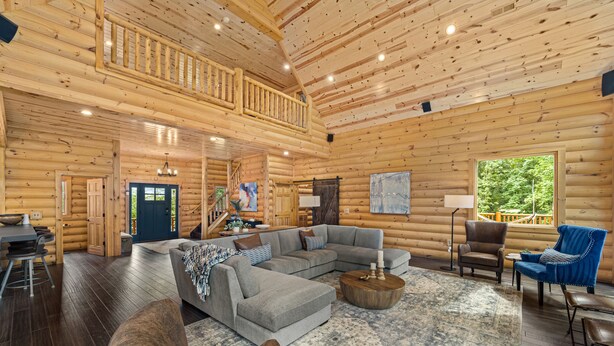 A log cabin interior with a living room, dining area, and a balcony. - Cabin, Pool, Hot Tub, Wineries and Mountains Oh My! (Culpeper)