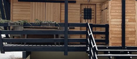 A wooden building with a metal staircase leading to a door marked '4A' and '4B'.