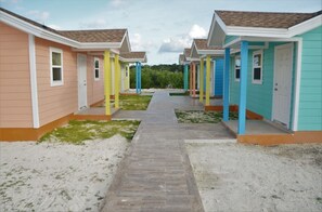 Rows of charming single-story buildings with pitched roofs and front porches line the property.