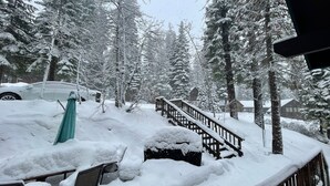 A snowy landscape with a wooden staircase leading up to a cabin. - Quiet & Large house - Hot Tub, Pool table, Fast WiFi  -  close to Kings Beach! (Tahoe Vista)