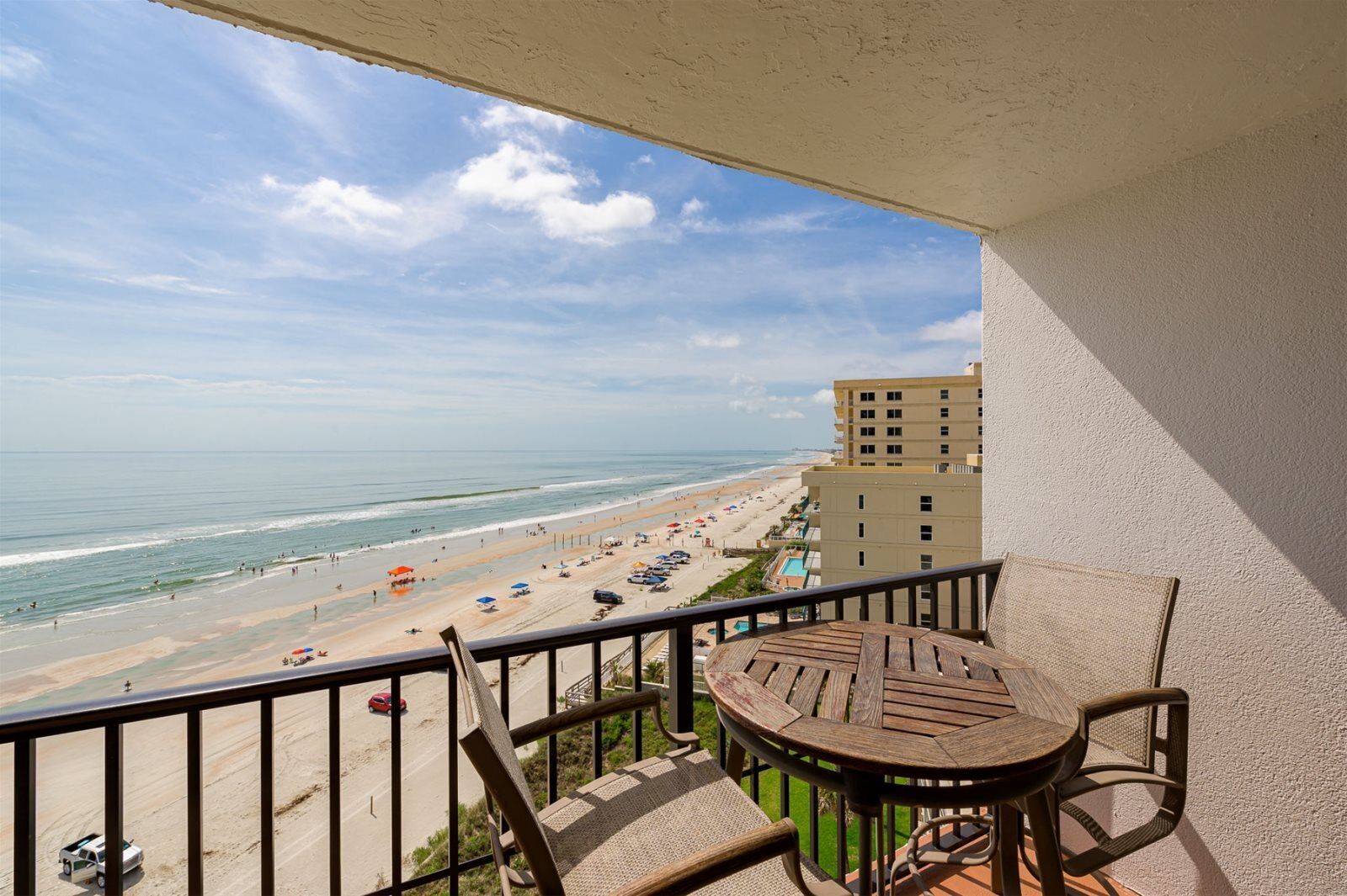 A balcony with a view of a beach and ocean.