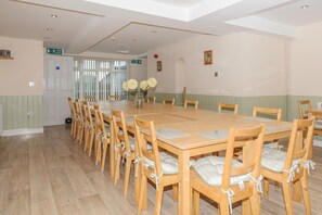 Enjoy meals in this dining area with a long table and comfortable chairs.