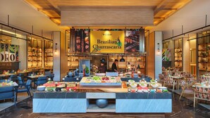 A restaurant with a buffet setup, a chef preparing food, and a sign reading 'Pedro Brazilian Churrascaria'. - Novotel Bangkok Future Park Rangsit (Thanyaburi)