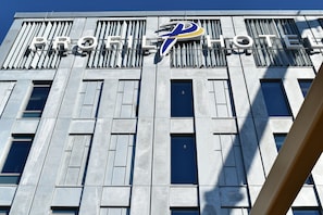 PROFILE HOTEL features a modern architectural design with a prominent logo above the entrance.