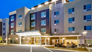 A multi-story hotel with a covered entrance and outdoor seating area. - TownePlace Suites by Marriott Asheville West (Asheville)