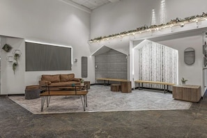 A modern interior with a brown leather sofa, a wooden bench, and a small table.