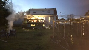 A two-story house with a covered patio and a fenced yard. - Quiet, large private backyard, fully equipped, dreamy beds! 
Short or long term. (Halifax)