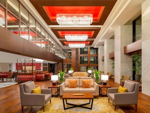 A spacious lobby with a high ceiling, large windows, and modern chandeliers. - Mövenpick Hotel Istanbul Asia Airport (Istanbul)