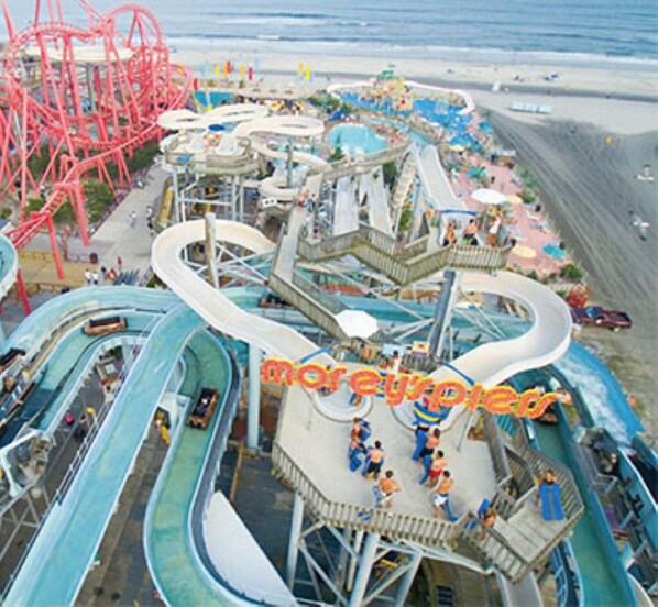 A water park with multiple slides and a red roller coaster. - 2 Bedroom Beachfront Ocean View, Pools Parking, Grills, Boardwalk. Sleeps six. (North Wildwood)