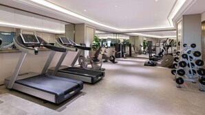 A modern gym with treadmills, stationary bikes, and weightlifting equipment. - Mercure Shijiazhuang People Square (Shijiazhuang)