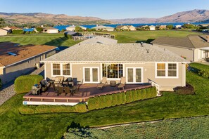 A residential house with a patio, a swimming pool, and a view of the mountains. - Wapato Point Uplake View Home - Across the Street from Pool & Park (Manson)