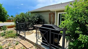 A house with a patio area, a barbecue grill, and a metal fence. - Townhouse in a quiet culdesac, easy access to all Black Hills area attractions. (Rapid City)