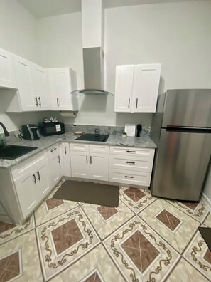 Fridge, microwave, stovetop, coffee/tea maker