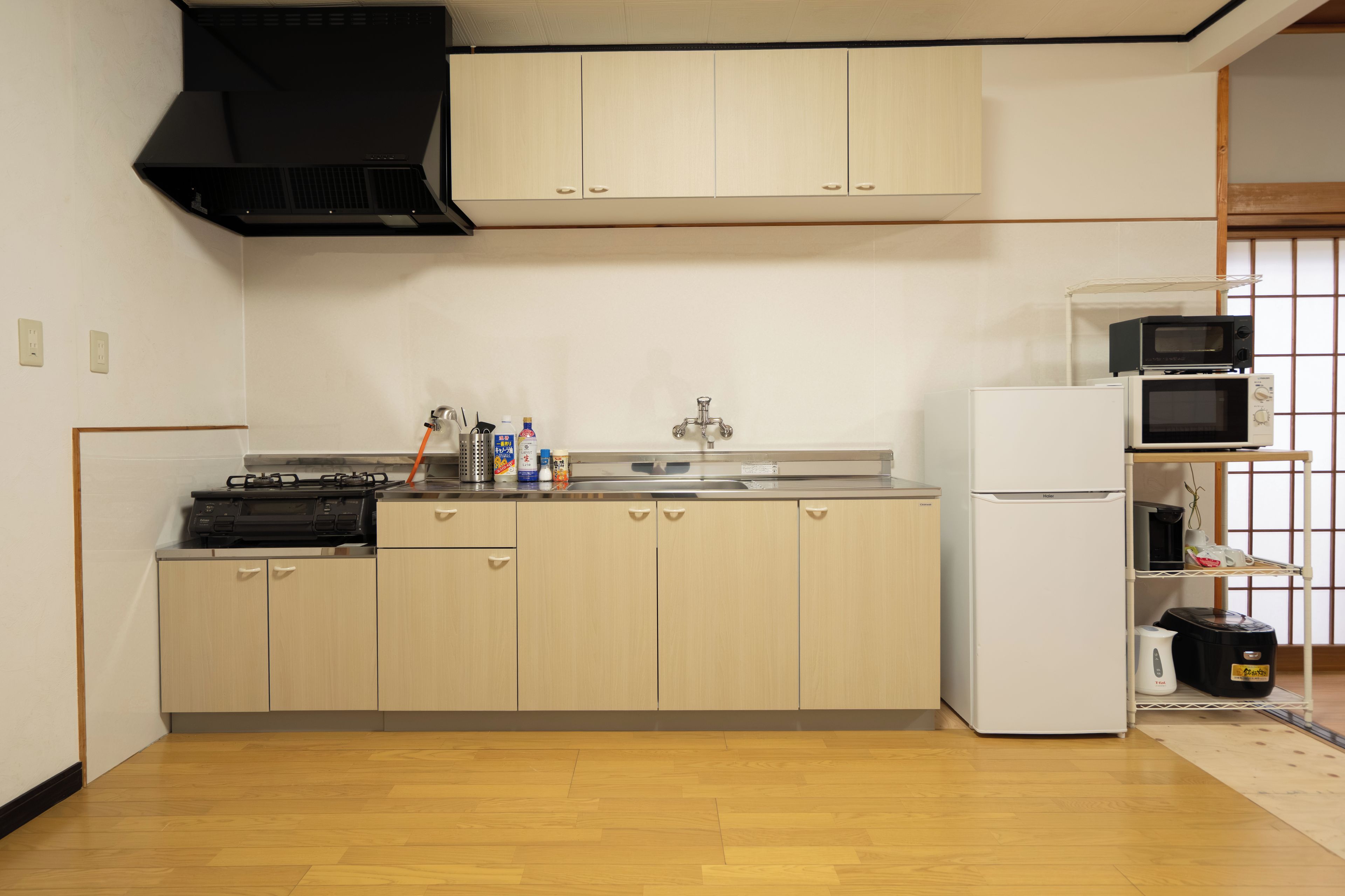 A compact kitchen with a stove, sink, and microwave.
